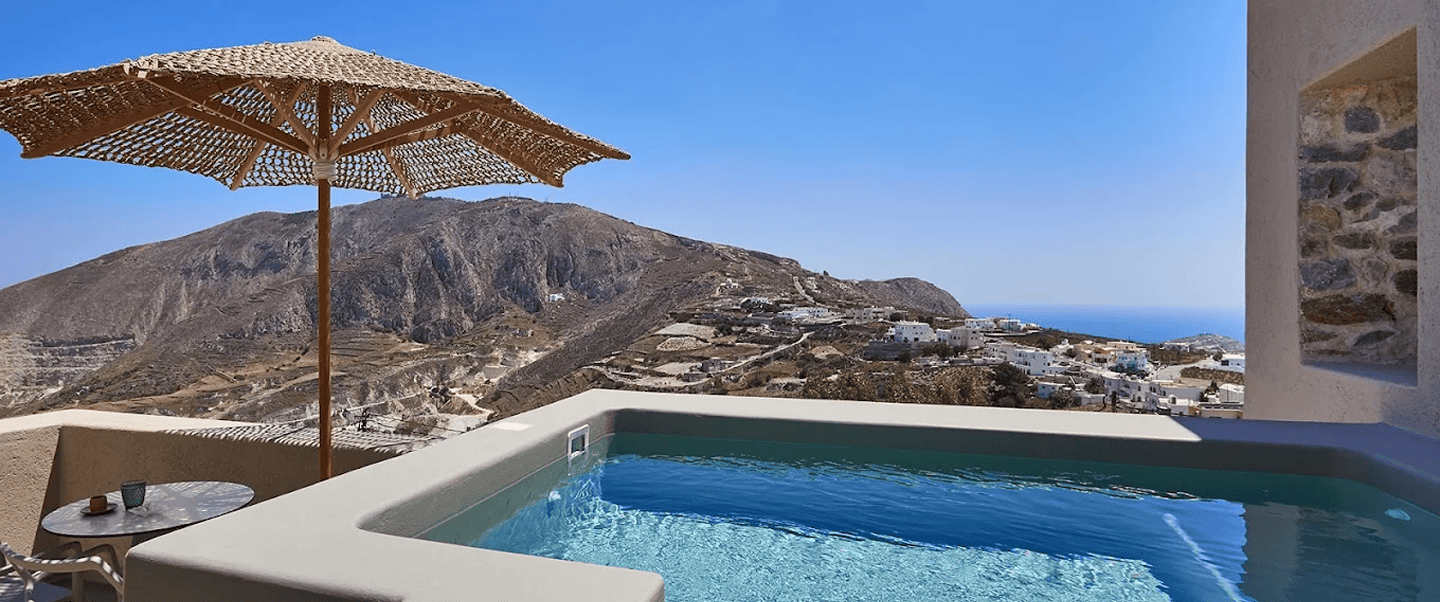 Infinity pool overlooking the Cyclades landscape and Aegean Sea.