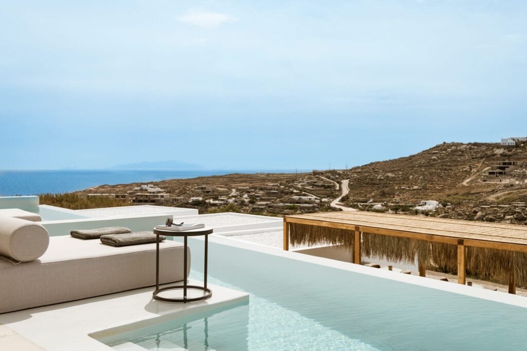 Elegant pool suite with side sea view in Cyclades, perfect for relaxing holidays.