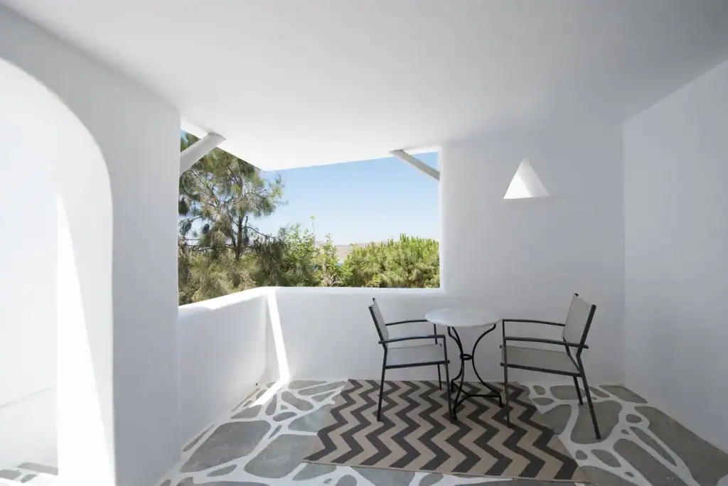 Side sea view balcony in superior room with outdoor seating. Perfect for relaxing and enjoying the s.