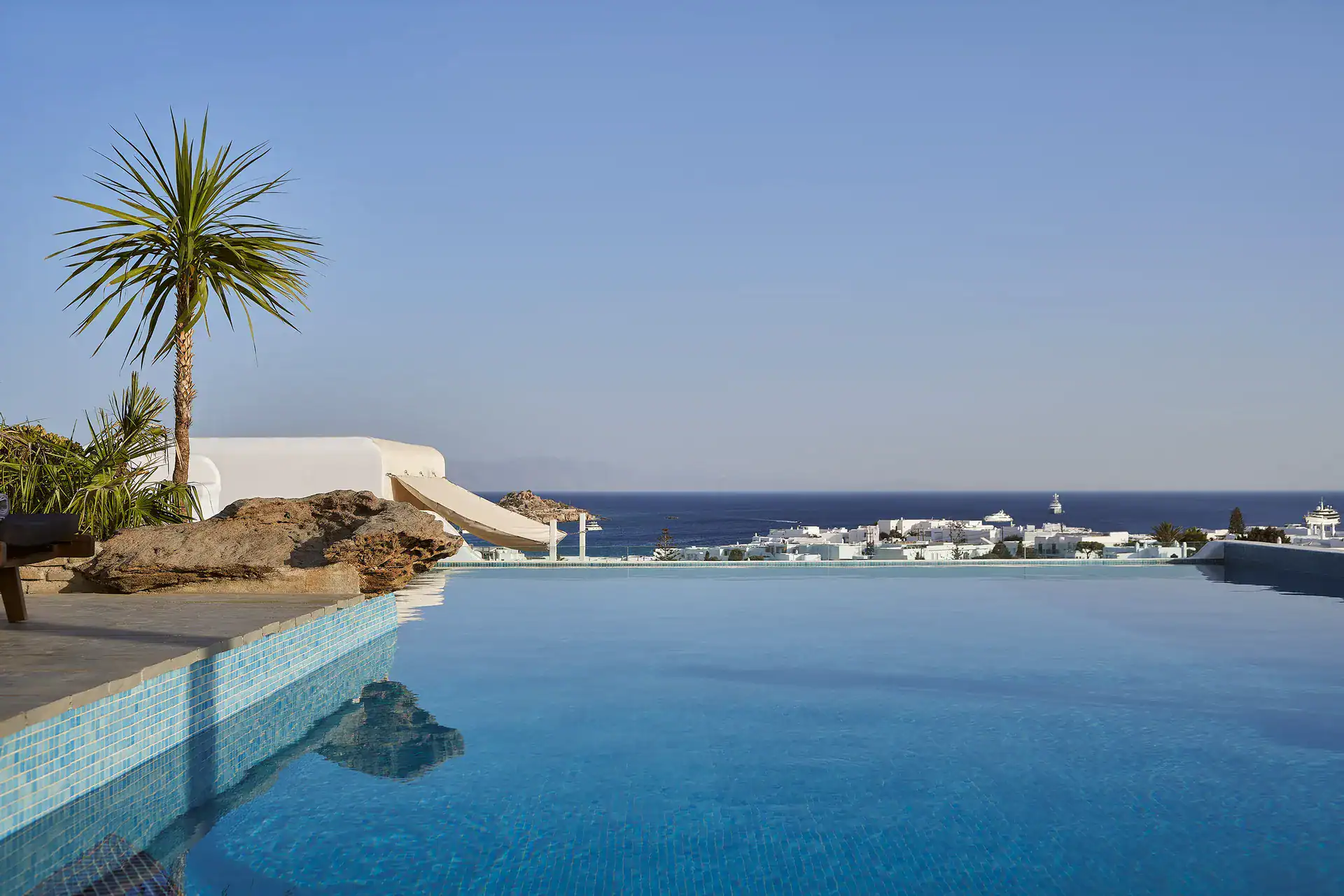 Infinity pool overlooking the Aegean Sea with scenic island views.