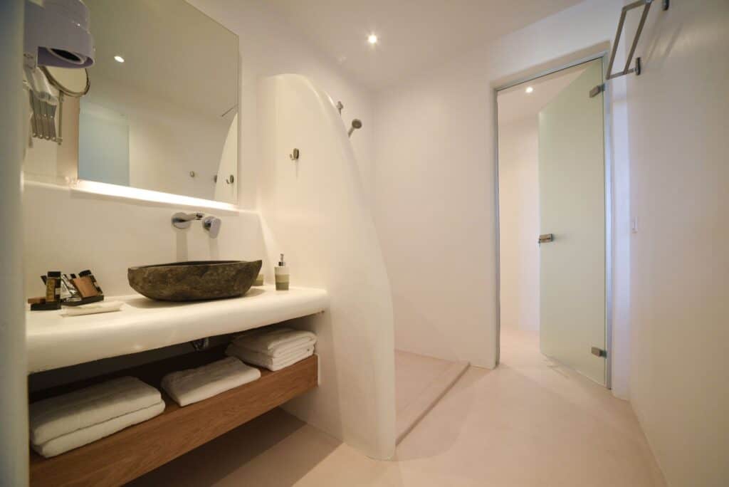 Luxurious master suite with plunge pool in the Cyclades, featuring minimalist design and elegant bat.