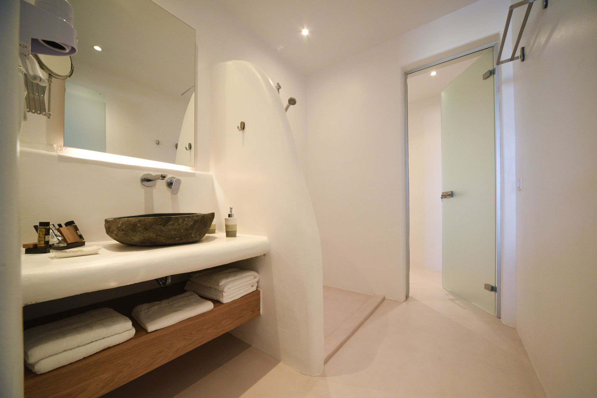 Luxurious master suite with plunge pool in the Cyclades, featuring minimalist design and elegant bat.