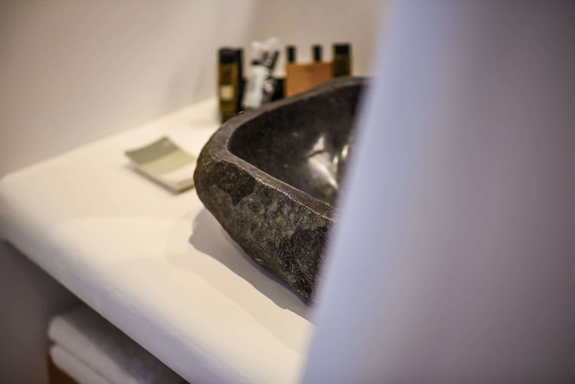 Elegant stone sink in a modern master suite with plunge pool at Mr and Mrs White Hotels Cyclades.