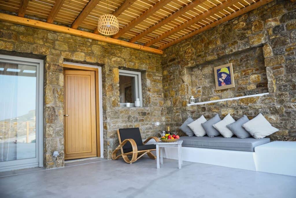 Luxurious master suite with plunge pool, stone walls, and modern decor at Mr and Mrs White Hotels Cy.