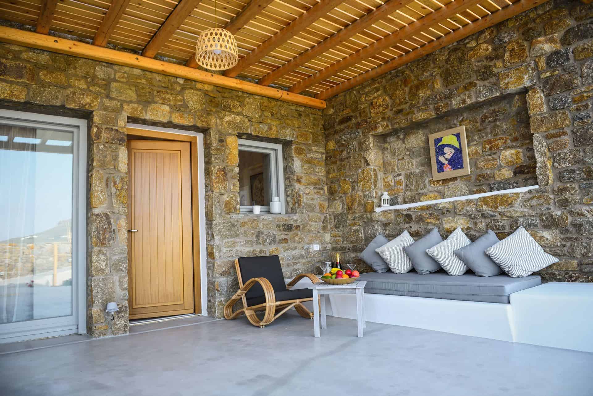 Luxurious master suite with plunge pool, stone walls, and modern decor at Mr and Mrs White Hotels Cy.