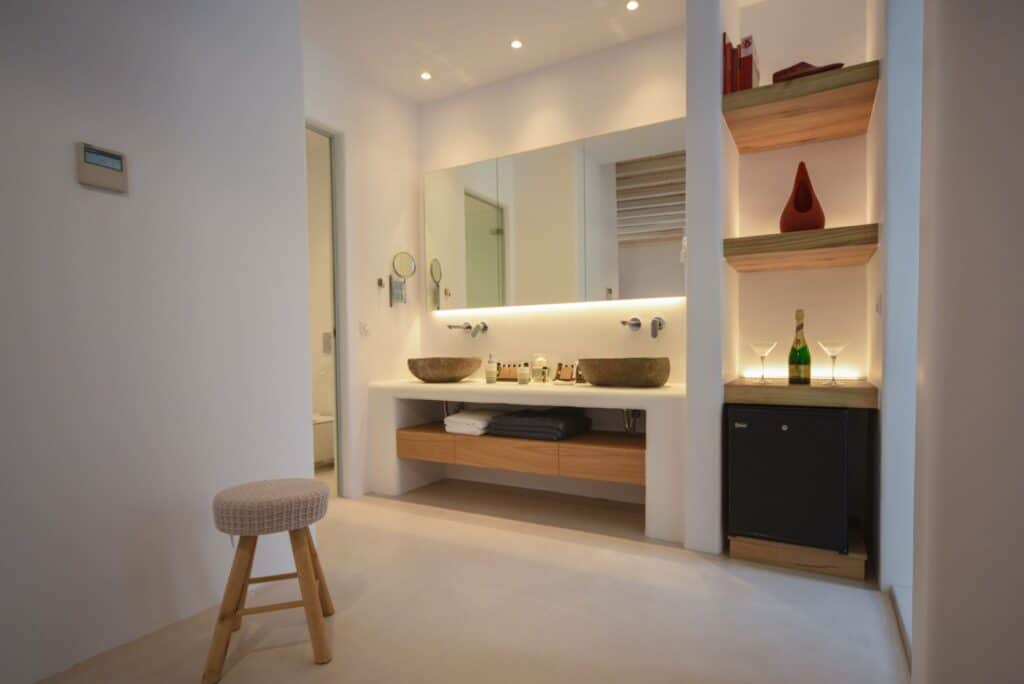 Luxurious executive suite featuring a private plunge pool, contemporary decor, and elegant bathroom.