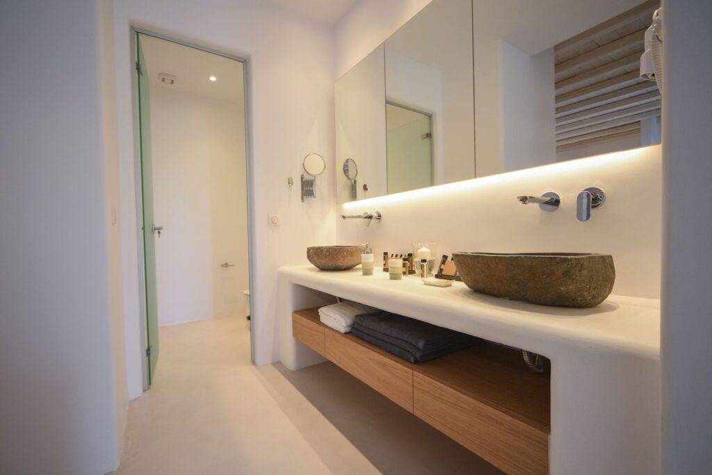 Elegant bathroom with stone sinks and modern decor in the Executive Suite with plunge pool.