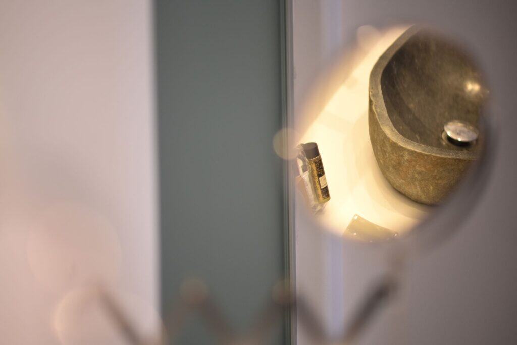 Elegant stone sink with modern faucet in executive suite bathroom.