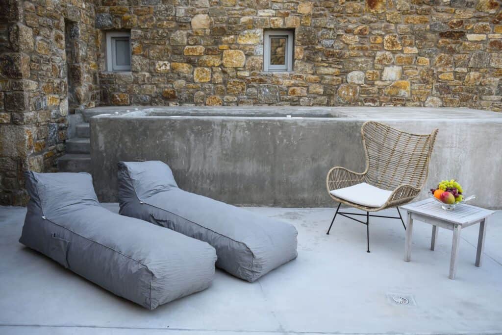 Relax outdoor lounge with sunbeds and a chair near the plunge pool at Mr and Mrs White Hotels Cyclad.