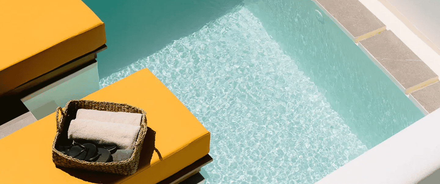 Elegant poolside scene at Mr and Mrs White Paros Suites, perfect for relaxing vacations in the Cycla.