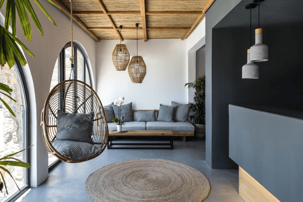 Elegant Mykonos boutique hotel lounge with stylish seating and natural light.