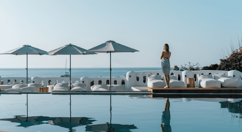 Woman enjoying the infinity pool at Penelope Village, Cyclades, Greece.