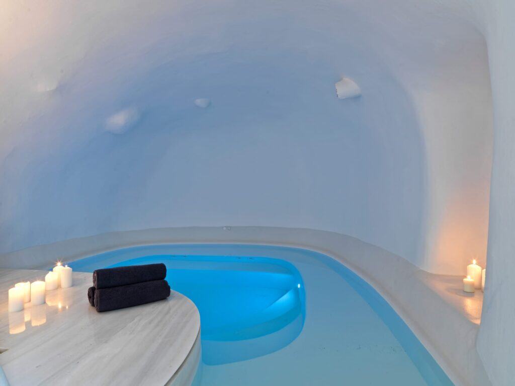 Indoor pool at Heavens Edge Villa, Cyclades, with relaxing candlelit ambiance.