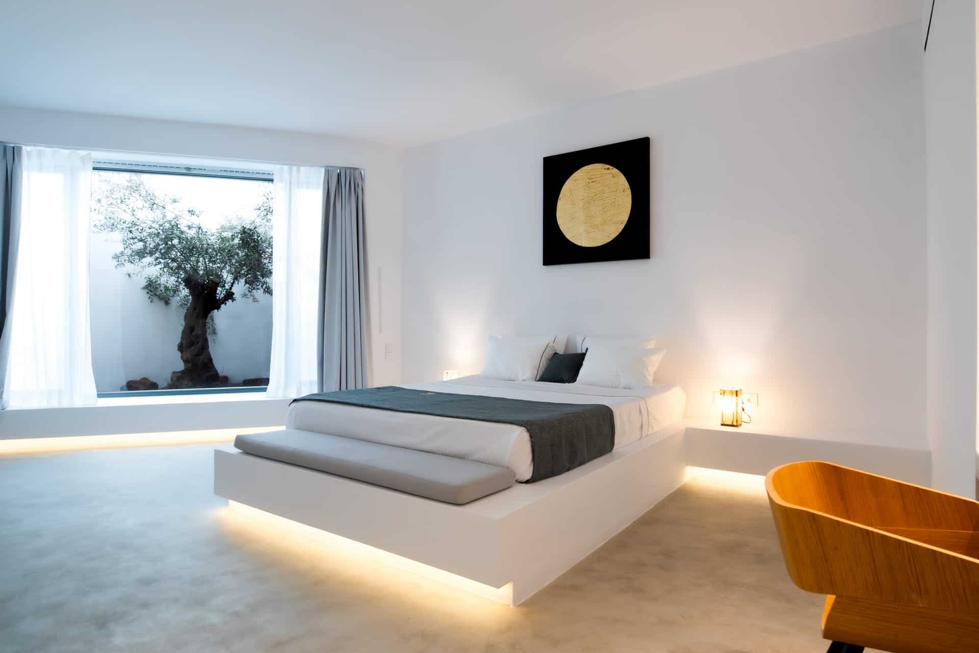Indoor pool and stylish bedroom at Heavens Edge Villa, part of Mr and Mrs White Hotels Cyclades. Lux.
