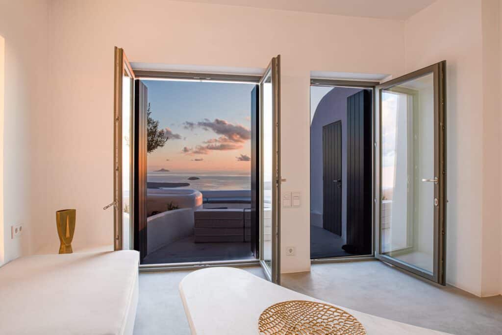 Stunning view from Heavens Edge Villa with indoor pool and open doors to outdoor sea scenery.