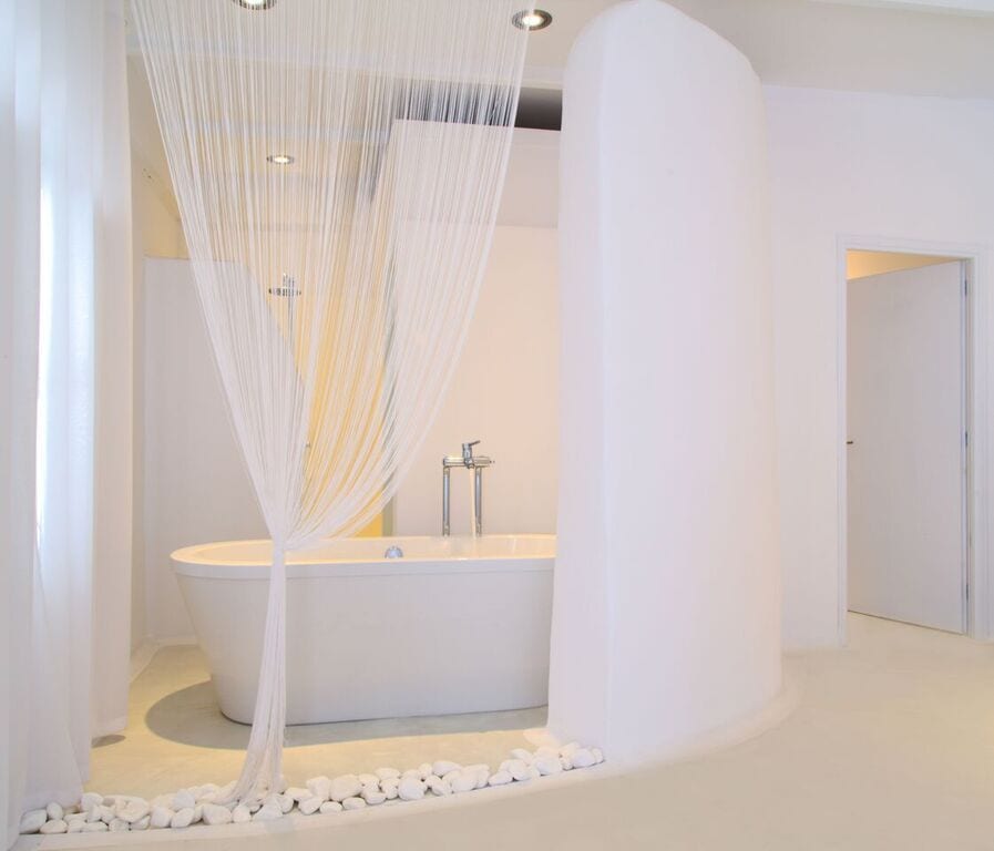 Sea view Notos Suite with bathtub, modern white interior, relaxing ambiance, perfect for romantic ge.