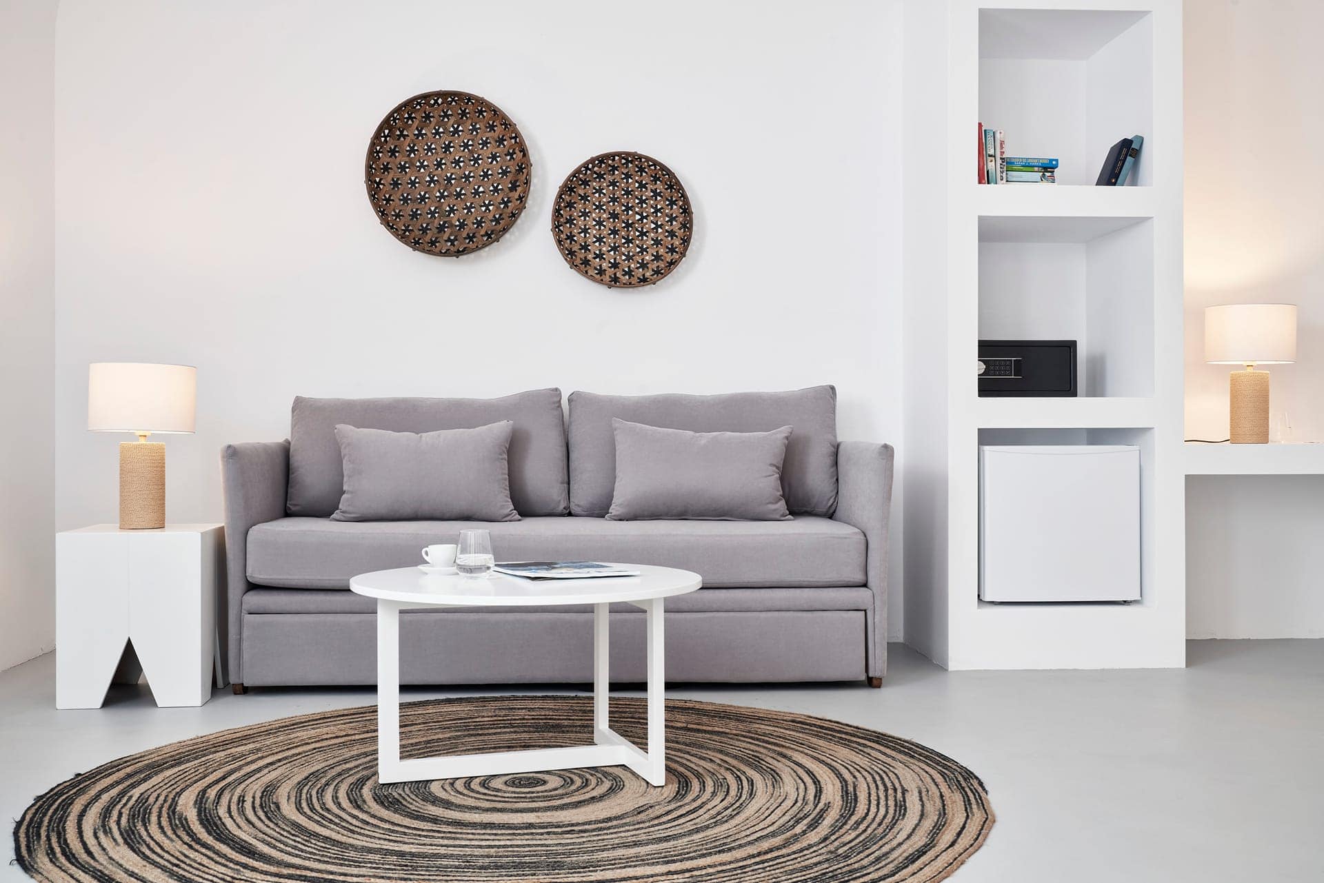Elegant one-bedroom suite with garden view, stylish decor, and comfortable seating in Cyclades hotel.