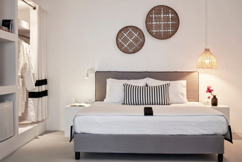 Elegant bedroom in Mr and Mrs White Hotels Cyclades with garden view.