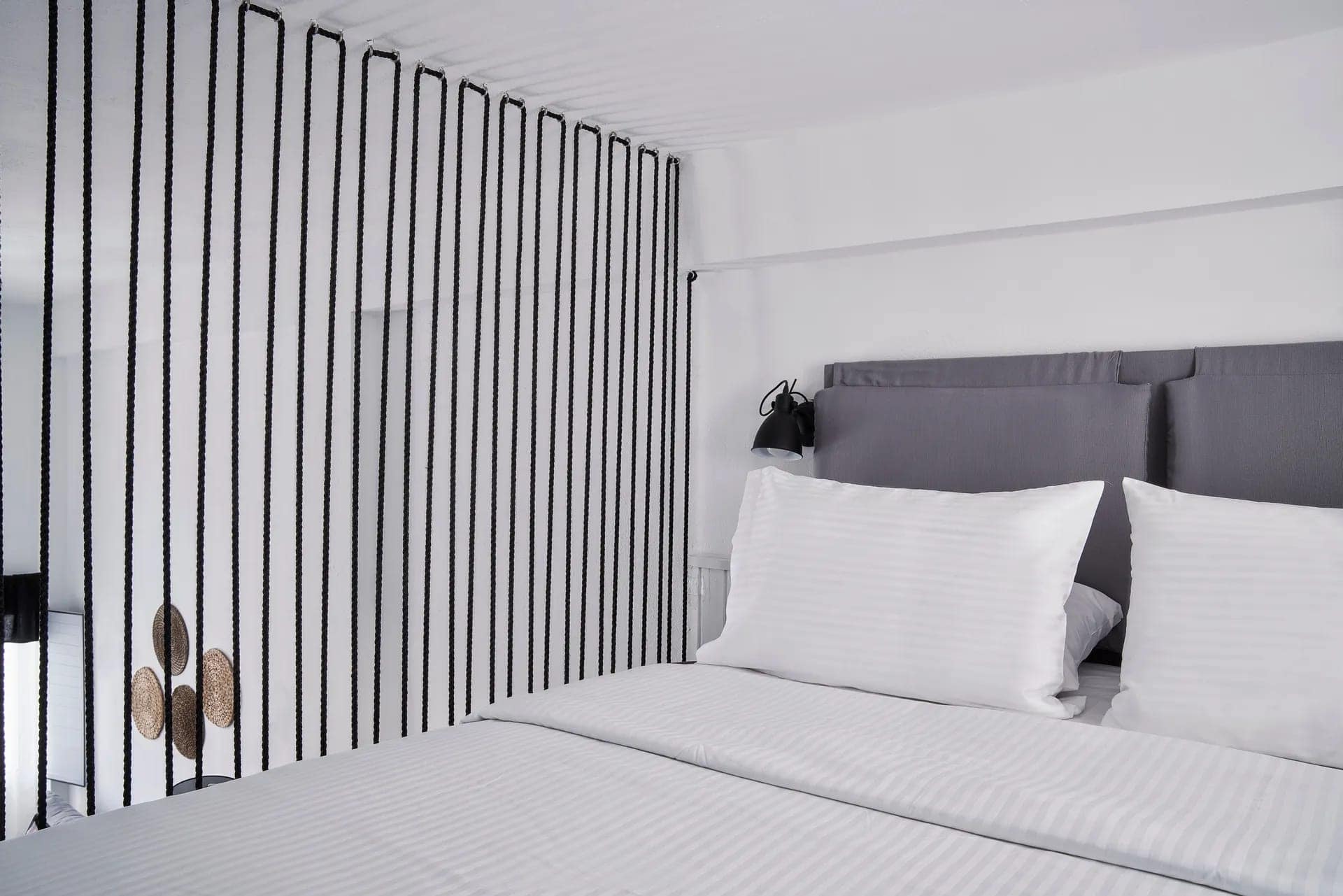 Caldera view superior room with modern decor and comfortable bedding in the Cyclades. Perfect for a.