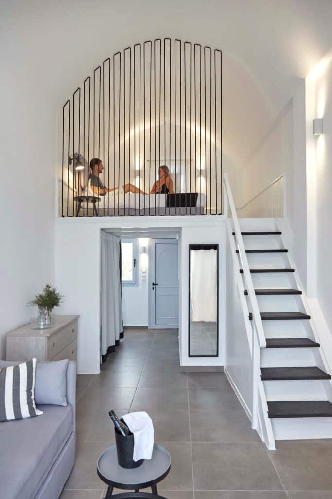 Caldera view from a superior hotel room in the Cyclades, featuring modern decor and cozy ambiance.