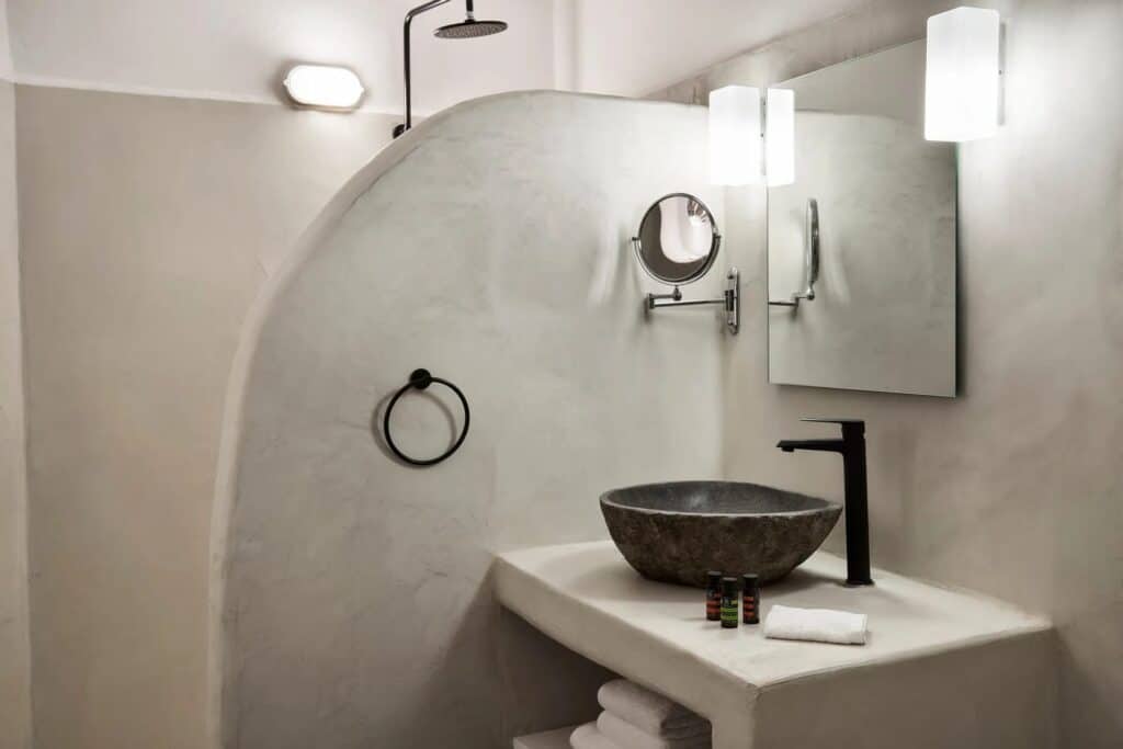 Elegant Cyclades hotel superior room with caldera view, modern bathroom, and stylish decor. Perfect.