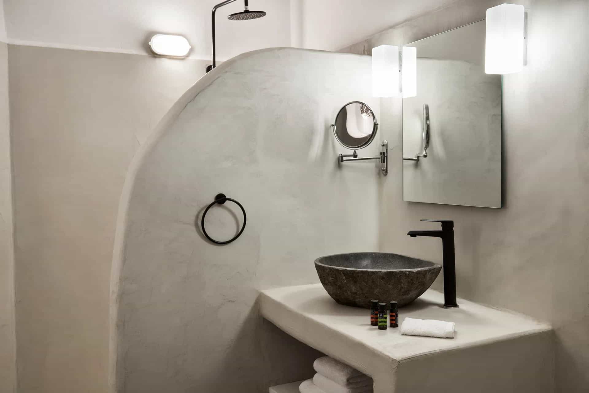 Elegant Cyclades hotel superior room with caldera view, modern bathroom, and stylish decor. Perfect.