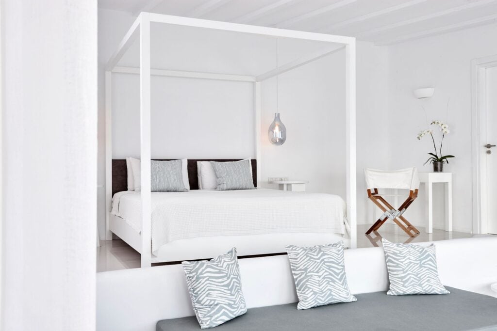 Elegant sea view Notos Suite with modern decor and white furnishings.