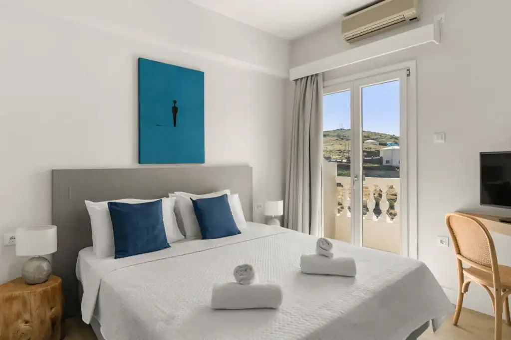 Elegant suite with sea view, modern decor, and comfortable bedding in Cyclades. Perfect for a relaxi.