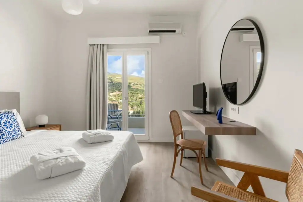 Superior Triple Room with Sea View, bright and airy with balcony, modern amenities, and scenic ocean.