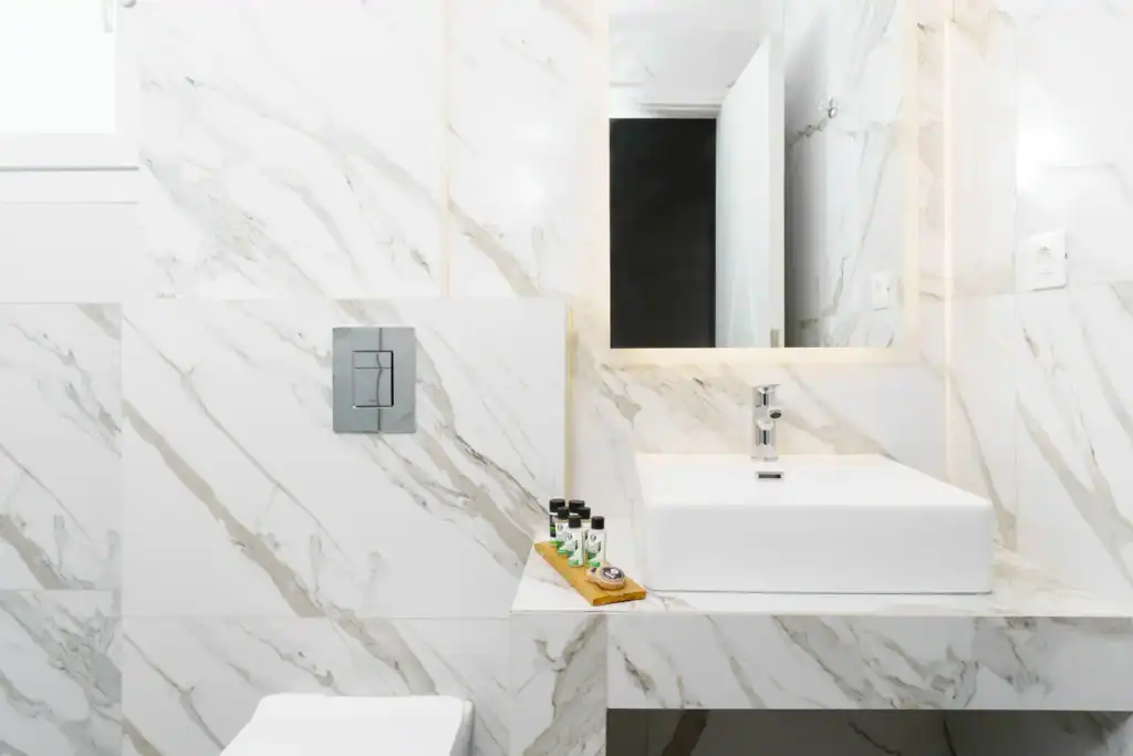 Bright suite bathroom with sea view, modern fixtures, and marble accents. Perfect for a relaxing sta.