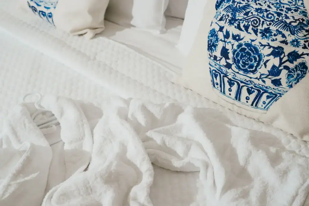 Sea view suite with elegant decor and cozy bedding at Mr and Mrs White Hotels Cyclades.