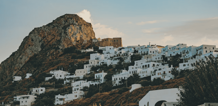 Scenic view of white Cycladic houses on a hillside in Santorini, Greece.