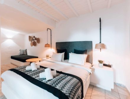 Elegant hotel room in the Cyclades with modern decor and comfortable bedding. Perfect for a relaxing.