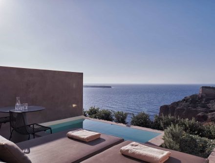 Infinity pool overlooking the Aegean Sea in Cyclades, Greece. Luxurious suite with sea views, modern.