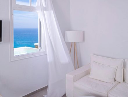 Sea View Honeymoon Suite with Balcony and White Decor.