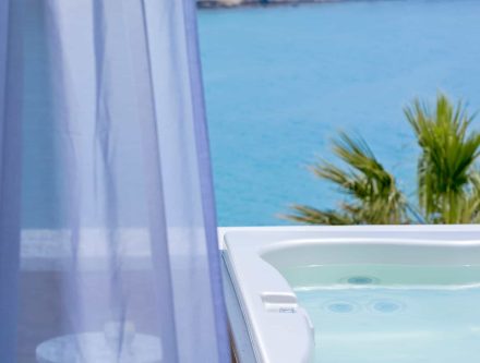 Luxurious double room with sea view, private heated tub, and ocean scenery in Cyclades.