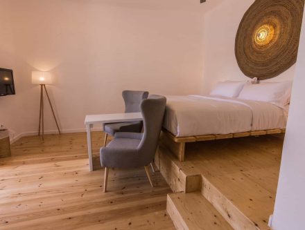 Sea View Sarakiniko Suite with comfortable bed and modern decor.