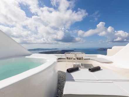 Outdoor hot tub with stunning Aegean Sea views in a luxury suite. Perfect for relaxing and enjoying.