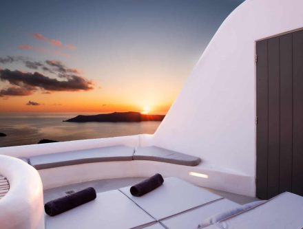 Stunning sunset view from Heavens Edge Villa with outdoor seating in Cyclades.