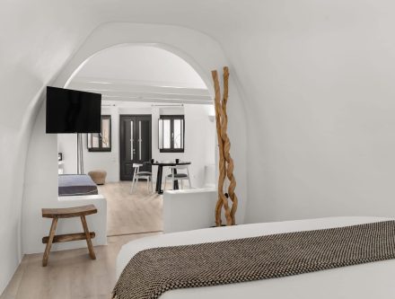 Elegant junior suite with caldera view, modern decor, and cozy furnishings in Cyclades. Perfect for.