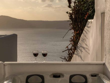Outdoor jetted tub overlooking the Caldera in a Cyclades studio. Perfect for relaxing and enjoying s.