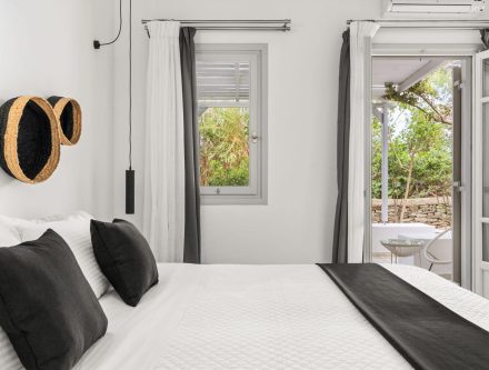 Elegant room with patio access, white walls, and black accents, perfect for a relaxing stay at Mr an.