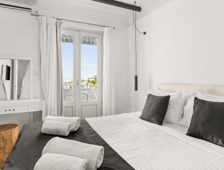 Sea view family room with modern decor and balcony in Cyclades, Greece. Perfect for relaxing stays w.