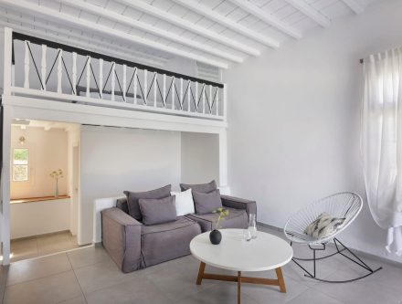 Spacious suite featuring a heated jetted tub, modern decor, and comfortable seating, perfect for rel.