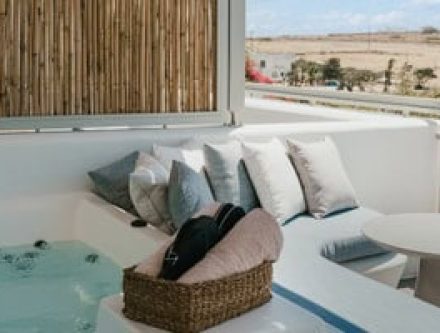 Deluxe double room with private jet tub and outdoor seating, perfect for relaxing in the Cyclades.