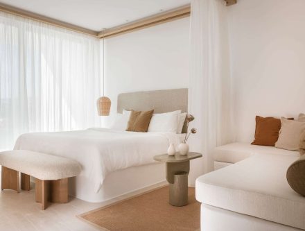 Elegant Junior Pool Suite with 35m² space, modern decor, and cozy seating area. Perfect for a relaxi.