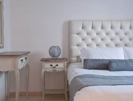 Elegant bedroom with plush white tufted headboard and stylish side tables.