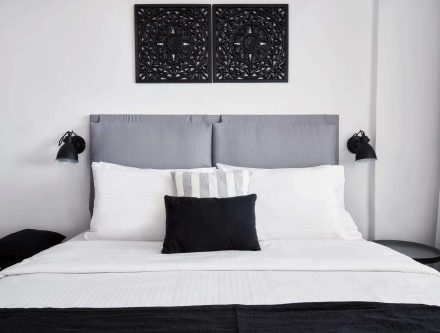 Elegant bedroom in Mr and Mrs White Hotels Cyclades with modern decor and caldera views.