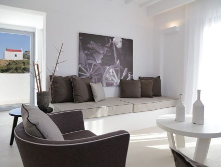 Deluxe suite with sea view, stylish interior, and comfortable seating in Mr and Mrs White Hotels Cyc.