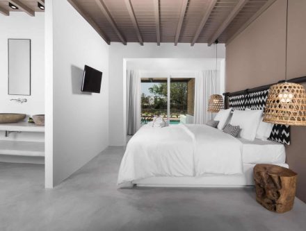 Elegant bedroom with private pool access and modern decor. Perfect for a luxurious stay in the Cycla.